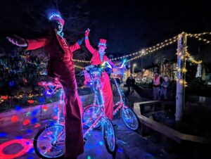 Christmas stilt walkers on stilt bicycles