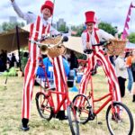 stilt walkers on bikes